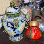 A 20TH CENTURY MAJOLICA STYLE DECORATIVE POTTERY JAR AND COVER DECORATED WITH YELLOW GLAZED FLOWERS,