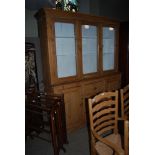 A LATE 19TH / EARLY 20TH CENTURY TWO PART PINE KITCHEN DRESSER, THE UPPER SECTION WITH THREE