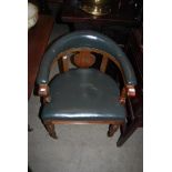 A LATE VICTORIAN GREEN LEATHERETTE UPHOLSTERED MAHOGANY HORSESHOE BACK ELBOW CHAIR