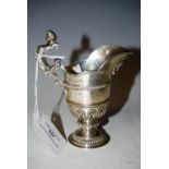 A LONDON SILVER HELMET SHAPED CREAM JUG, MAKERS MARK OF BIRCH & GAYDON, 5 TROY OZS.