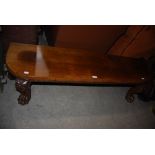 LATE 19TH/ EARLY 20TH CENTURY OAK WINDOW SEAT/ LOW TABLE ON FOUR MASK AND PAW CARVED SUPPORTS.
