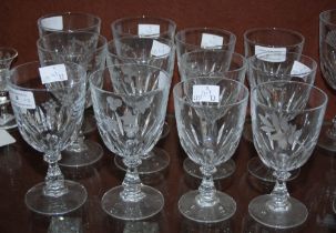 TWELVE CLEAR GLASS WINE GOBLETS, TWO SETS OF SIX, EACH WITH WHEEL-CUT DECORATION OF DIFFERENT