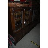 PAIR OF STAINED OAK AND LEADED GLASS DISPLAY CABINETS, TOGETHER WITH ANOTHER SIMILAR STAINED OAK AND