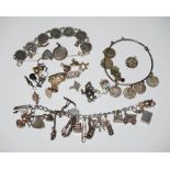 VINTAGE WHITE METAL CHARM BRACELET, BAG OF ASSORTED LOOSE CHARMS, AN EARLY 20TH CENTURY THREE