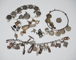 VINTAGE WHITE METAL CHARM BRACELET, BAG OF ASSORTED LOOSE CHARMS, AN EARLY 20TH CENTURY THREE