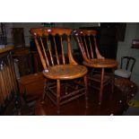 SET OF FOUR LATE 19TH / EARLY 20TH CENTURY ELM AND OAK KITCHEN CHAIRS WITH SPINDLE GALLERY BACKS AND