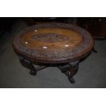 LATE 19TH/ EARLY 20TH CENTURY OVAL INDIAN CARVED WOOD OCCASIONAL TABLE ON FOUR ELEPHANT MASK