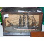 A MODEL SHIP IN DISPLAY CASE