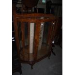 EARLY 20TH CENTURY WALNUT MIRROR-BACK BOWFRONT TWO-DOOR DISPLAY CABINET.