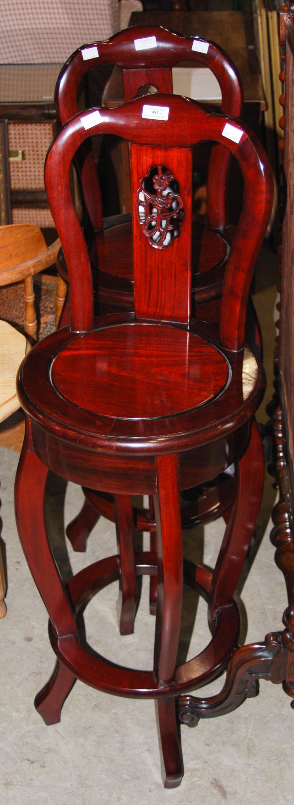 PAIR OF CHINESE DARK WOOD REVOLVING HIGH CHAIRS WITH CIRCULAR-SHAPED SEATS.