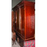 EARLY 20TH CENTURY MAHOGANY THREE-DOOR WARDROBE ON BASE FITTED WITH FIVE DRAWERS.