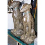 *A PAIR OF COMPOSITE SEATED HOUNDS WITH BRONZED FINISH