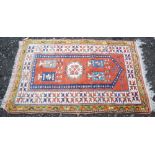 A SMALL PERSIAN CARPET, WITH BURNT ORANGE FIELD WITH BLUE AND WHITE MEDALLIONS/BANNERS IN A WHITE