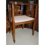 AN EDWARDIAN MAHOGANY AND BOXWOOD LINED TUB CHAIR WITH FLEUR-DE-LIS UPHOLSTERED SEAT.