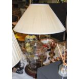 A CLEAR GLASS JAR AND COVER MOUNTED AS A TABLE LAMP AND SHADE