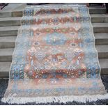 A PERSIAN CARPET, WITH PALE PINK FIELD WITH IVORY, BEIGE AND GREEN MEDALLIONS WITH BIRDS, THE