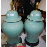 *A PAIR OF DECORATIVE CELADON GLAZED JAR AND COVER FORM TABLE LAMPS ON CIRCULAR WOODEN PLINTHS