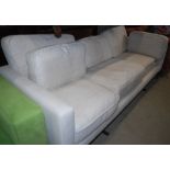 *A CONTEMPORARY THREE SEAT SOFA OF RECTANGULAR FORM, UPHOLSTERED IN OATMEAL COLOURED FABRIC WITH