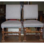 *A PAIR OF OAK HALL CHAIRS WITH HERRINGBONE UPHOLSTERED BACKS AND SEATS WITH SILVERED STUD DETAIL