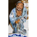 CHINESE BLUE GLAZED PORCELAIN FIGURE OF A BEARDED MAN HOLDING A GOURD-SHAPED VESSEL, 29CM HIGH.