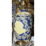 *A DECORATIVE BLUE, YELLOW AND GREEN GLAZED TABLE LAMP WITH FLOWER AND FOLIATE SCROLL DETAIL