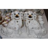 PAIR OF STAFFORDSHIRE POTTERY KING CHARLES SPANIELS WITH INLAID GLASS EYES.