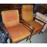 A PAIR OF MID 20TH CENTURY ARMCHAIRS WITH ORANGE UPHOLSTERED BACKS AND LOOSE CUSHION SEATS