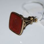 YELLOW METAL AND RED AGATE SEAL WITH INTAGLIO CARVED ARMORIAL.