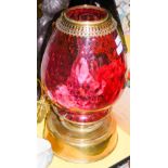 LATE 19TH CENTURY BRASS AND CRANBERRY GLASS PARAFFIN BURNING LAMP CONVERTED TO ELECTRICITY.