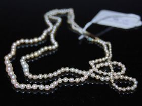 TWO SINGLE STRAND GRADUATED PEARL NECKLACES.