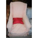 A 19TH CENTURY ARMCHAIR UPHOLSTERED IN WHITE CALICO WITH LOOSE RED CHECKERED COVERS ON TAPERED
