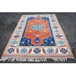 A PERSIAN CARPET, THE INDIGO FIELD WITH LARGE CENTRAL BURNT ORANGE MEDALLION, THE IVORY FLORAL