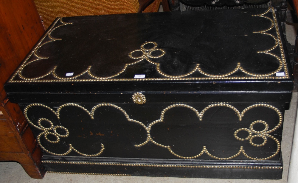*A 19TH CENTURY EBONISED PINE BLANKET BOX WITH LATER BRASS STUDDED DETAIL