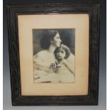 PHOTOGRAPHY INTEREST - AN EARLY 20TH CENTURY SEPIA PHOTOGRAPH TITLED "A MOTHERS PRIDE"