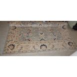 A 20TH CENTURY PERSIAN STYLE CARPET, THE RECTANGULAR LIGHT BLUE FIELD DECORATED WITH ALL-OVER