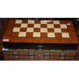 TWO MODERN LACQUER FINISH FOLDING GAMES BOARDS, THE OUTER WITH A CHESS BOARD, THE INNER WITH A