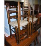 SET OF FOUR RUSH-SEATED LADDER-BACK CHAIRS