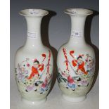 A PAIR OF EARLY 20TH CENTURY CHINESE PORCELAIN FAMILLE ROSE BOTTLE VASES BOTH DECORATED WITH FIVE