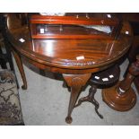 EARLY 20TH CENTURY MAHOGANY DEMILUNE CARD TABLE WITH GREEN BAIZE LINED INTERIOR, FOUR SHELL CARVED