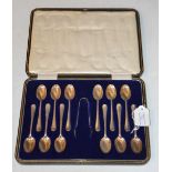 A CASED SET OF TWELVE SHEFFIELD SILVER TEA SPOONS AND SUGAR TONGS