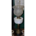 A LATE 19TH CENTURY PARAFFIN BRASS BURNING LAMP WITH OPAQUE GLASS RESERVOIR, FROSTED GLASS SHADE AND