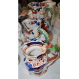 TWO GRADUATED MASONS PATENT IRONSTONE CHINA SERPENT HANDLE JUGS TOGETHER WITH A SIMILAR IRONSTONE