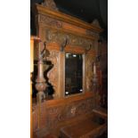 A VICTORIAN OAK MIRROR BACK HALL STAND, WITH MYTHICAL BEAST AND SCROLL CARVED DETAILS