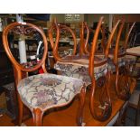 SET OF SIX VICTORIAN WALNUT BALLOON-BACK CHAIRS WITH FOLIATE UPHOLSTERED SEATS.