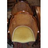 PAIR OF EARLY 20TH CENTURY MAHOGANY TUB CHAIRS WITH CANE-WORK BACK AND SIDES, YELLOW VELVET