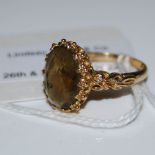 A 9CT GOLD DRESS RING SET WITH OVAL FACET CUT CITRINE TYPE STONE, SIZE O
