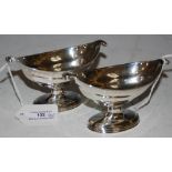 A PAIR OF GEORGE III SILVER SALTS, MAKERS MARK OF 'GH', LONDON 1802, OF BOAT FORM WITH SCROLL OVER