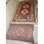 A 20TH CENTURY PERSIAN RUG, THE RECTANGULAR BLUE GROUND CENTRED WITH A LARGE MADDER GROUND MEDALLION