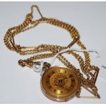 A 9CT GOLD CASED OPEN FACED FOB WATCH SUSPENDED ON LONG YELLOW METAL CHAIN