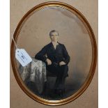 A VICTORIAN OVERPAINTED PHOTOGRAPH OF A GENTLEMAN, OF OVAL FORM FRAMED UNDER GLASS, 27CM HIGH